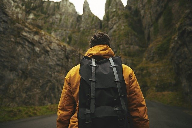 man hiking through wilderness